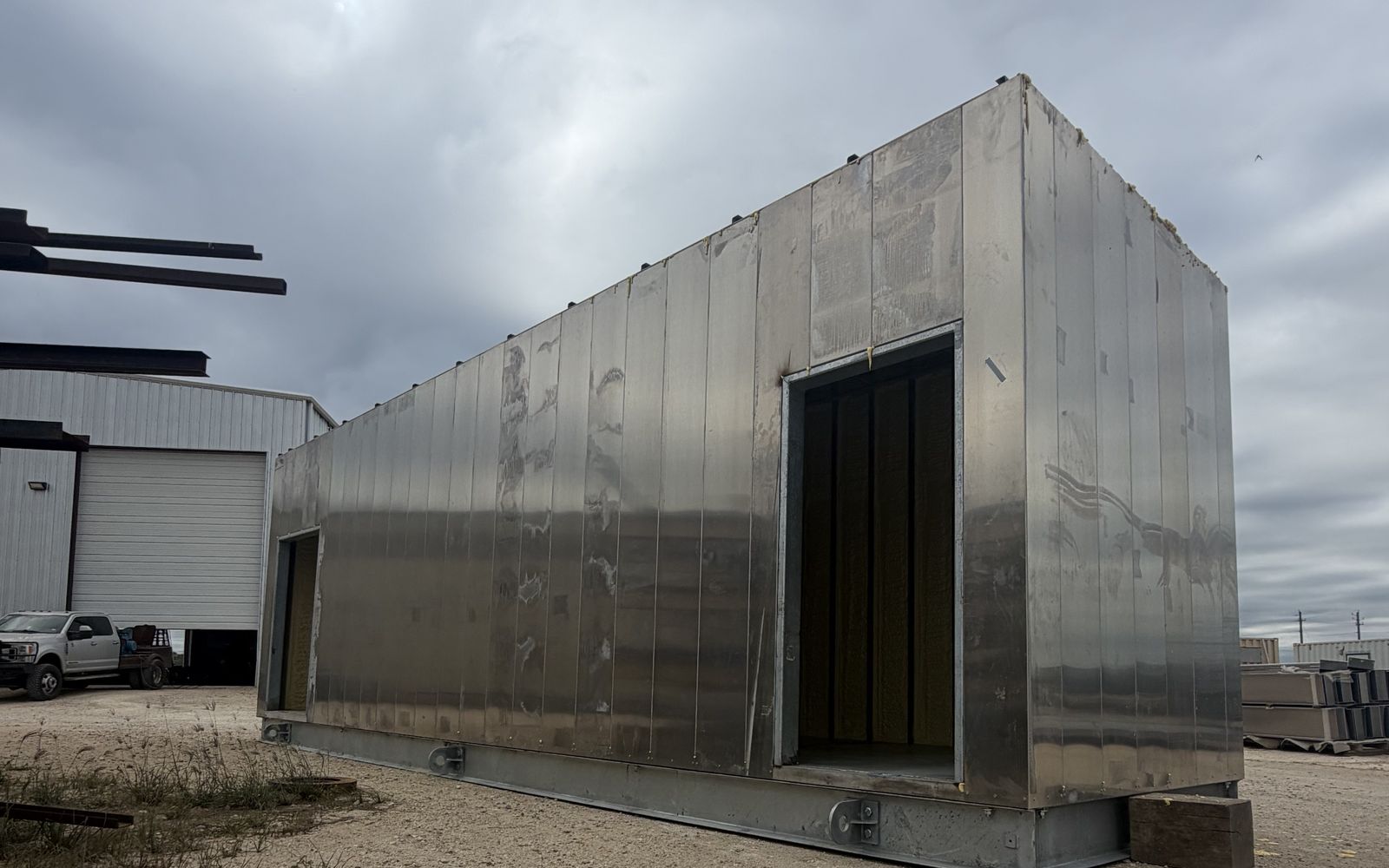 Aluminum-clad modular enclosure on a steel skid base