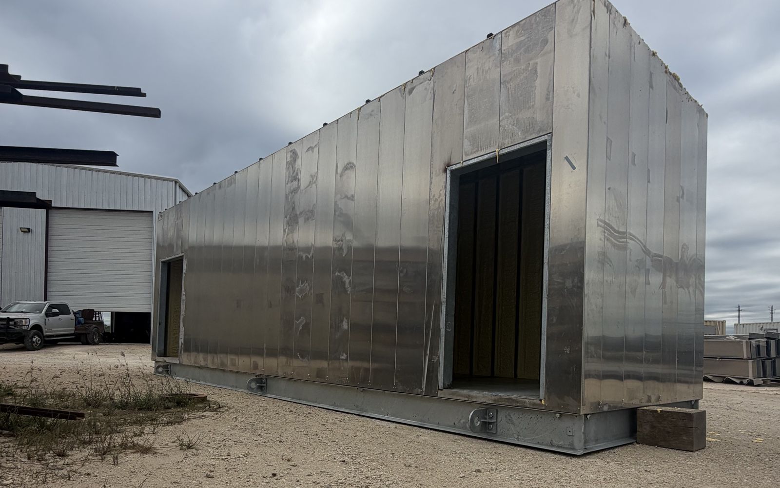 Finished aluminum electrical enclosure on a steel base, staged outdoors