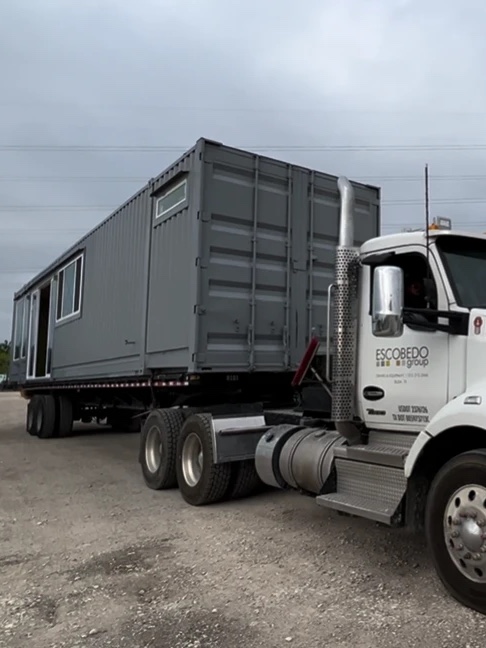 Finished modular unit loaded on a flatbed truck for delivery
